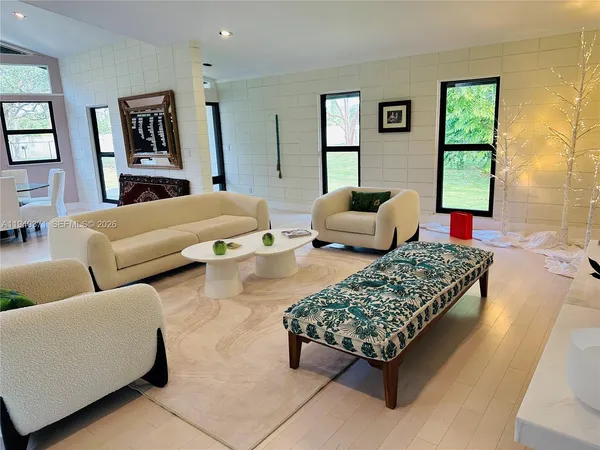 a bedroom with a bed couch and window