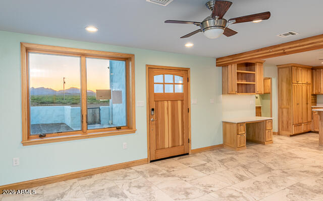 6233 West Airport Road Willcox, AZ 85643 - Photo 14 of 54 a view of a livingroom with wooden floor and a ceiling fan