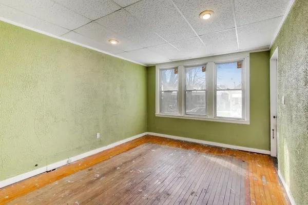 a view of room with window and wooden floor