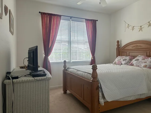 a bedroom with a bed and a window