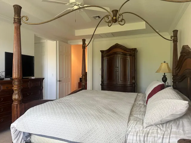 a bedroom with a bed and a flat screen tv