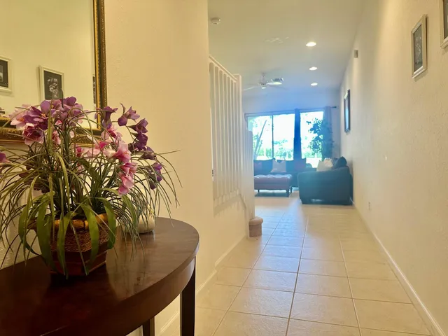 a view of hallway with furniture and a potted plant