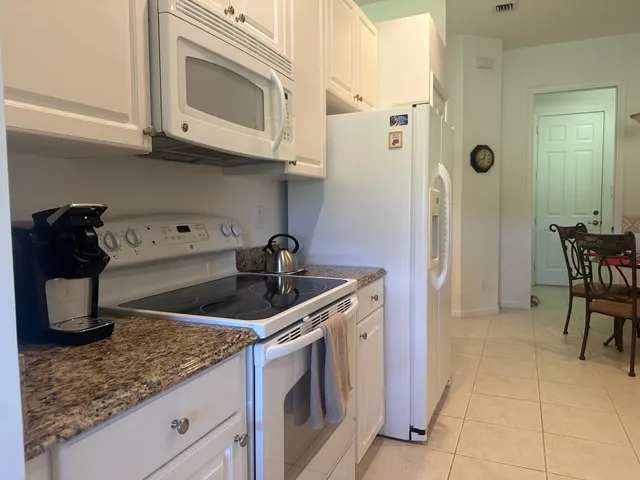 a kitchen with stainless steel appliances granite countertop a sink and cabinets