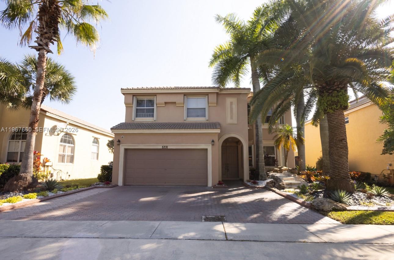 5331 Southwest 159th Avenue, Unit 5331 Miramar, FL 33027 - Photo 1 of 41 a front view of a house with a yard and garage