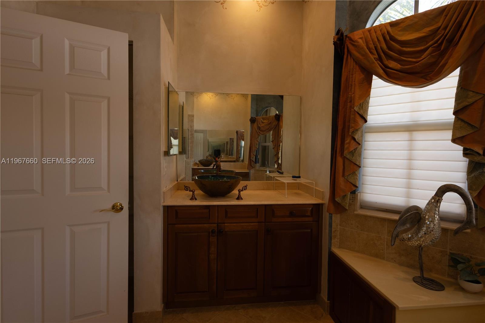 5331 Southwest 159th Avenue, Unit 5331 Miramar, FL 33027 - Photo 32 of 41 a bathroom with a sink and a mirror