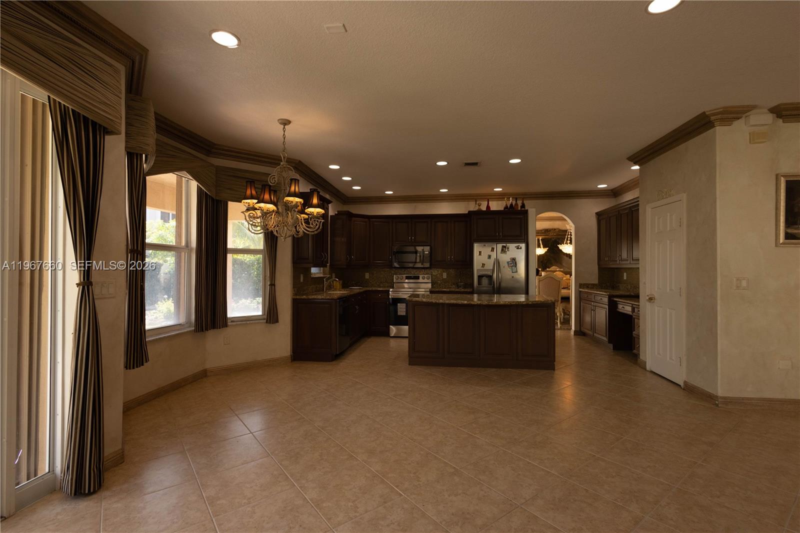 5331 Southwest 159th Avenue, Unit 5331 Miramar, FL 33027 - Photo 9 of 41 a view of a big room with windows and chandelier
