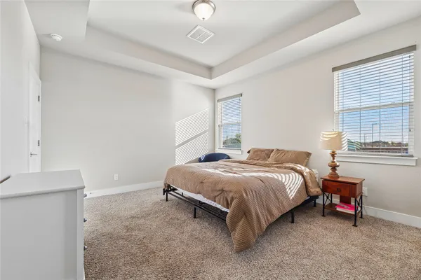 a bedroom with a bed and a couch