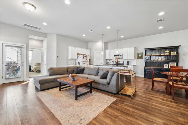 a living room with furniture and a wooden floor