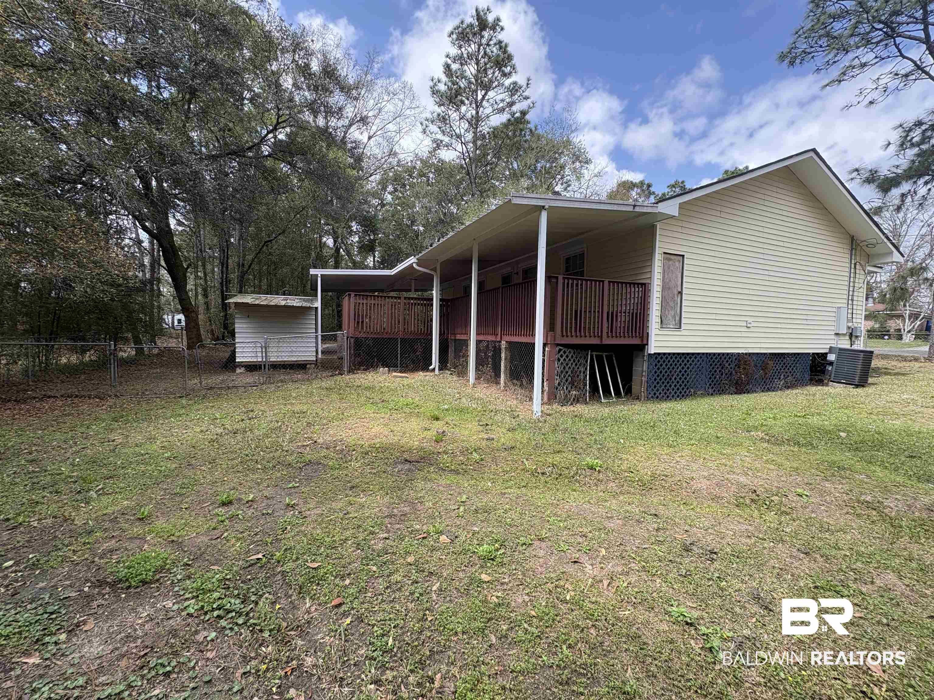 8065 Middle Ring Road Mobile, AL 36619 - Photo 16 of 21 View of home's exterior with a carport, central air condition unit, a yard, and fence