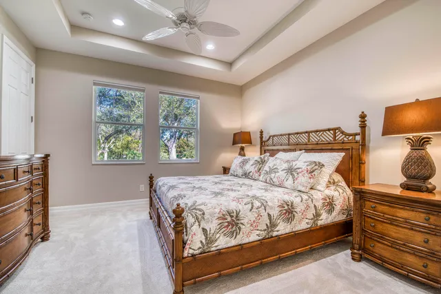 a bedroom with a bed and a flat tv screen on dresser