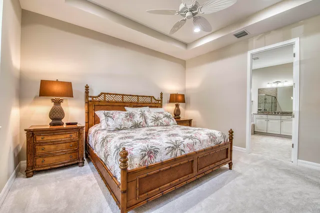 a bedroom with a bed and ceiling fan