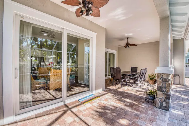 a view of a hall way with furniture and floor to ceiling window