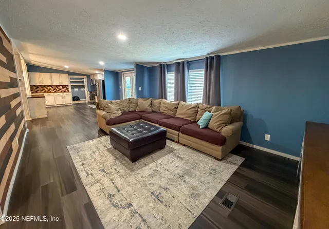 a view of a livingroom with furniture wooden floor and window