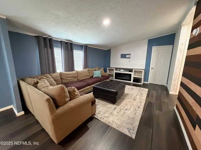 a close view of walk in closet with clothes and shoes