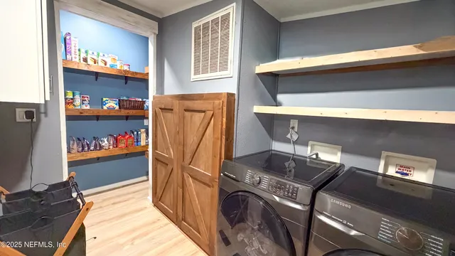 a bedroom with a bed a couch and a flat tv screen