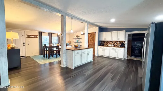 a kitchen with stainless steel appliances a stove top oven and a refrigerator