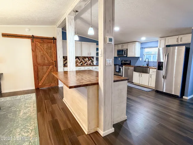 a view of a living room with kitchen