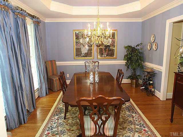 1408 Kings Branch Way Raleigh, NC 27614 - Photo 3 of 9 Invite your guests to dinner in this large dining room made for entertaining. Trey ceiling with medallion and extensive crown molding appointments are just a few of the custom details. You'll find hardwood floors throughout the first floor.