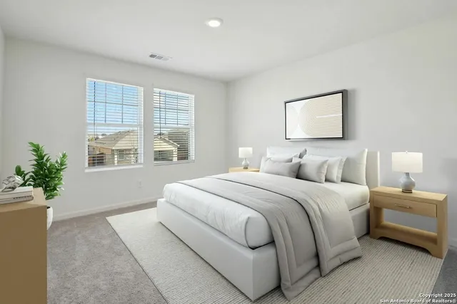 a bedroom with a large bed and a potted plant