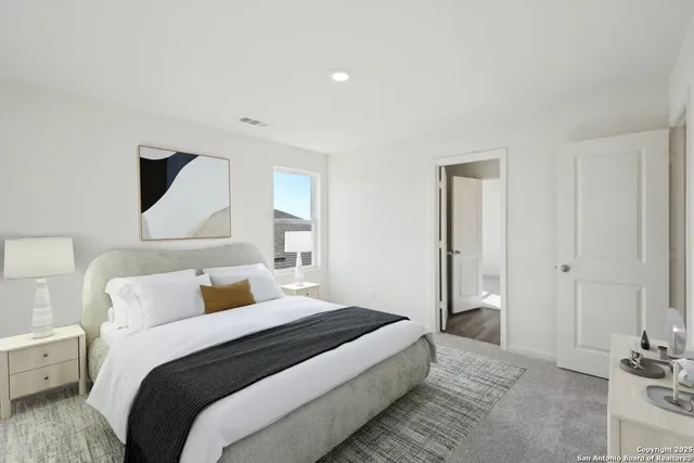 a bedroom with a bed and a lamp