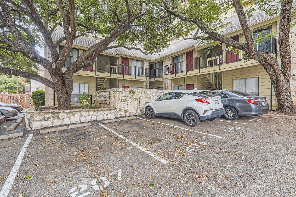 708 Graham Place, Unit 101 Austin, TX 78705 - Photo 12 of 12 a car parked in front of white house