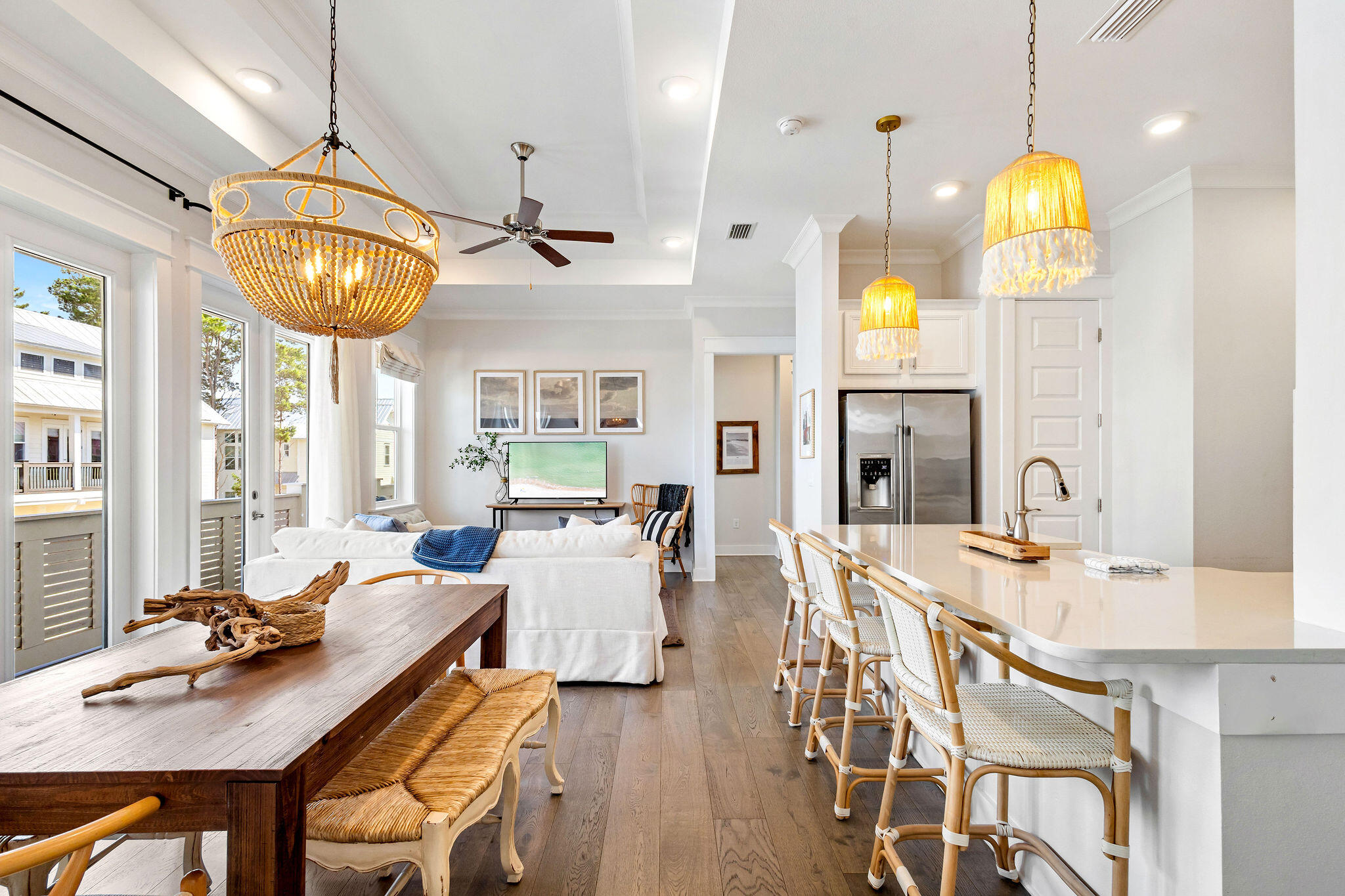 a view of a dining room with furniture a chandelier and wooden floor