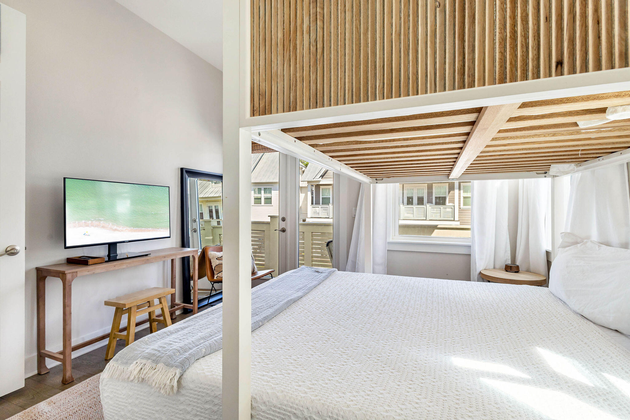 296 Milestone Dr Inlet Beach, Unit C Inlet Beach, FL 32461 - Photo 18 of 51 a bedroom with a bed and a flat screen tv