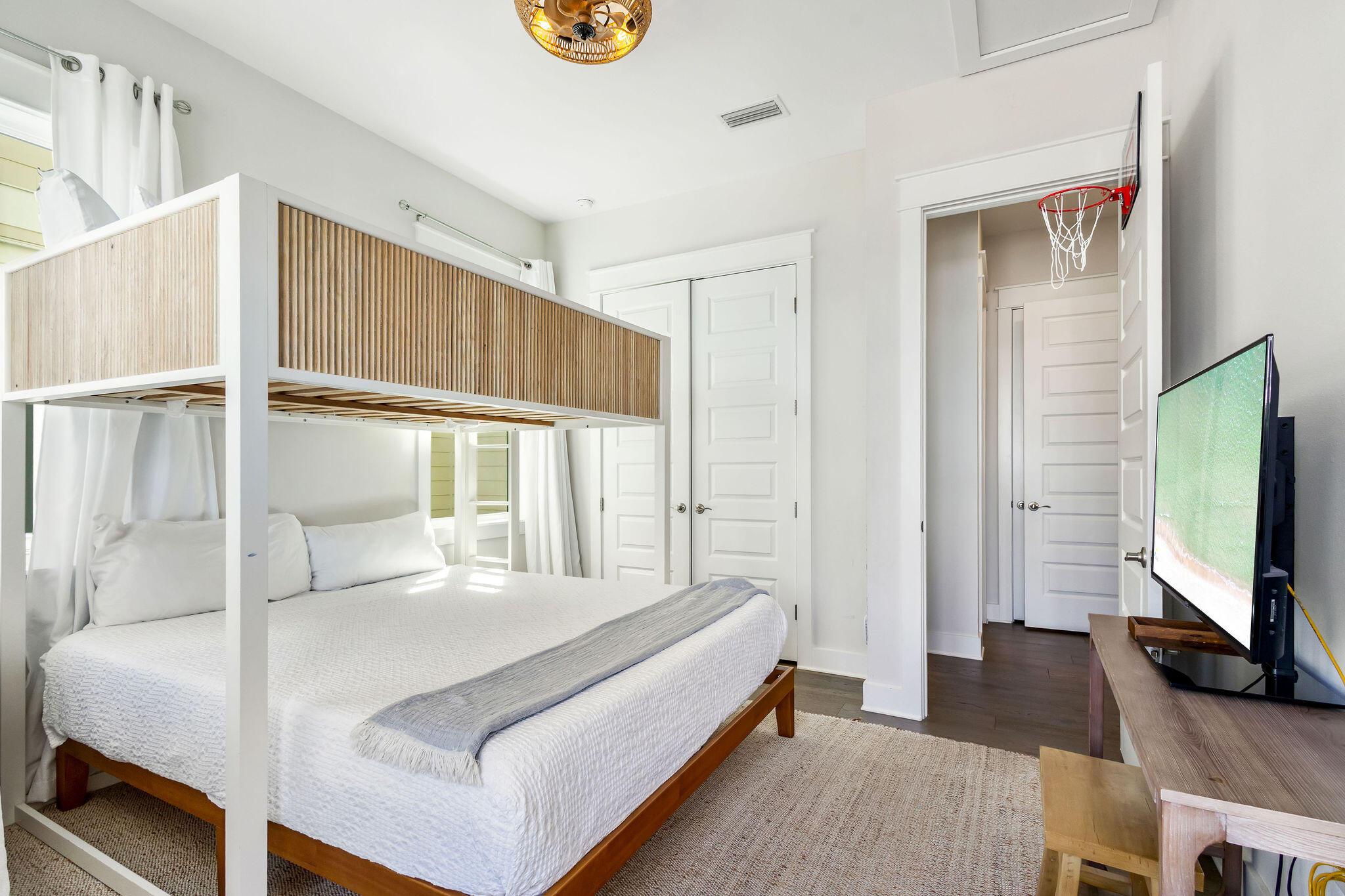 296 Milestone Dr Inlet Beach, Unit C Inlet Beach, FL 32461 - Photo 19 of 51 a living room with a bed furniture and a flat screen tv