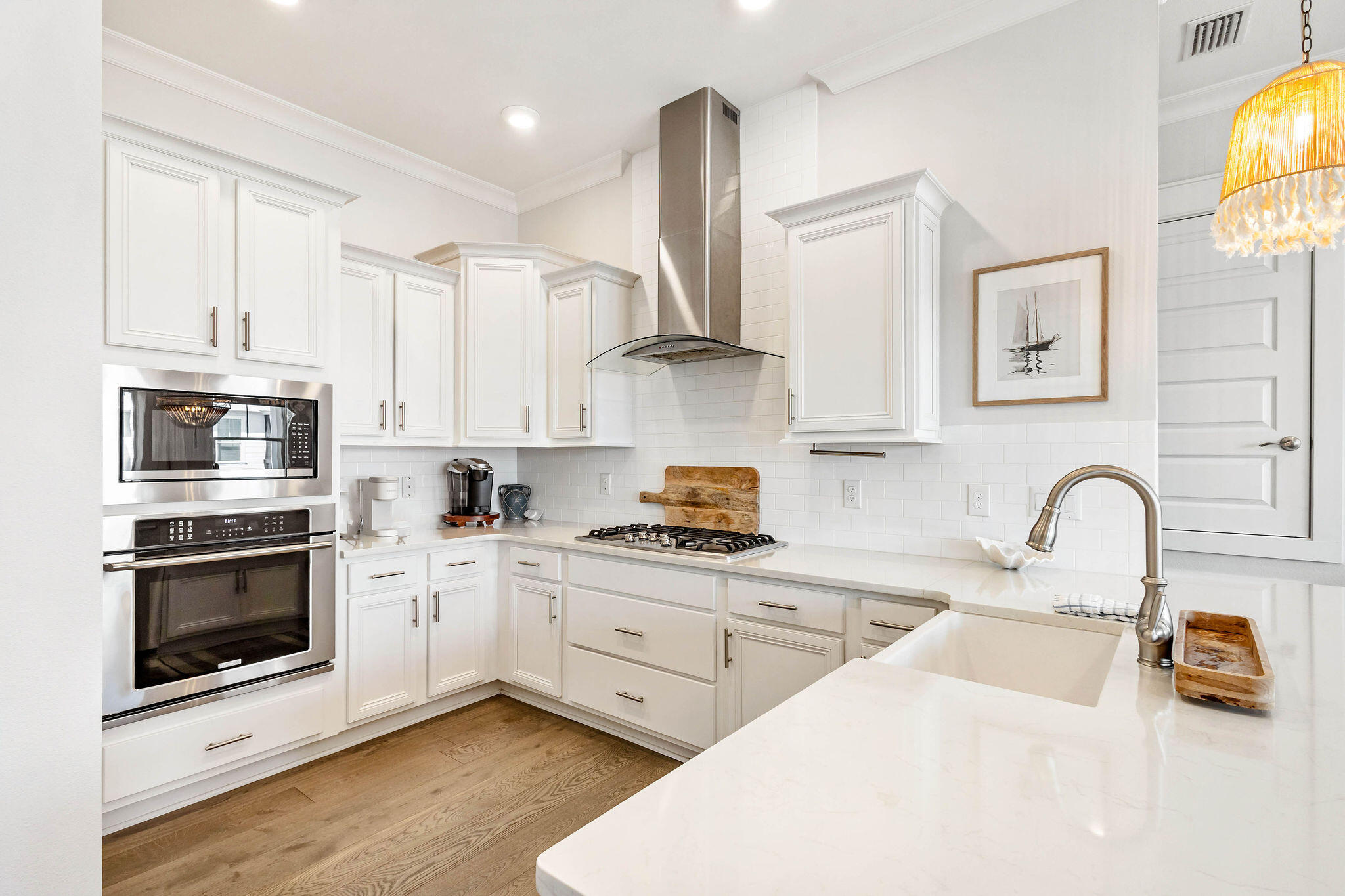 296 Milestone Dr Inlet Beach, Unit C Inlet Beach, FL 32461 - Photo 3 of 51 a kitchen with stainless steel appliances kitchen island granite countertop a stove a sink and a microwave