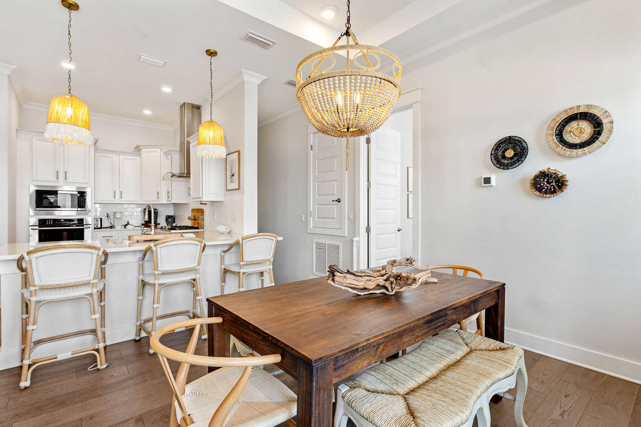 296 Milestone Dr Inlet Beach, Unit C Inlet Beach, FL 32461 - Photo 7 of 51 a kitchen with a table chairs and white cabinets