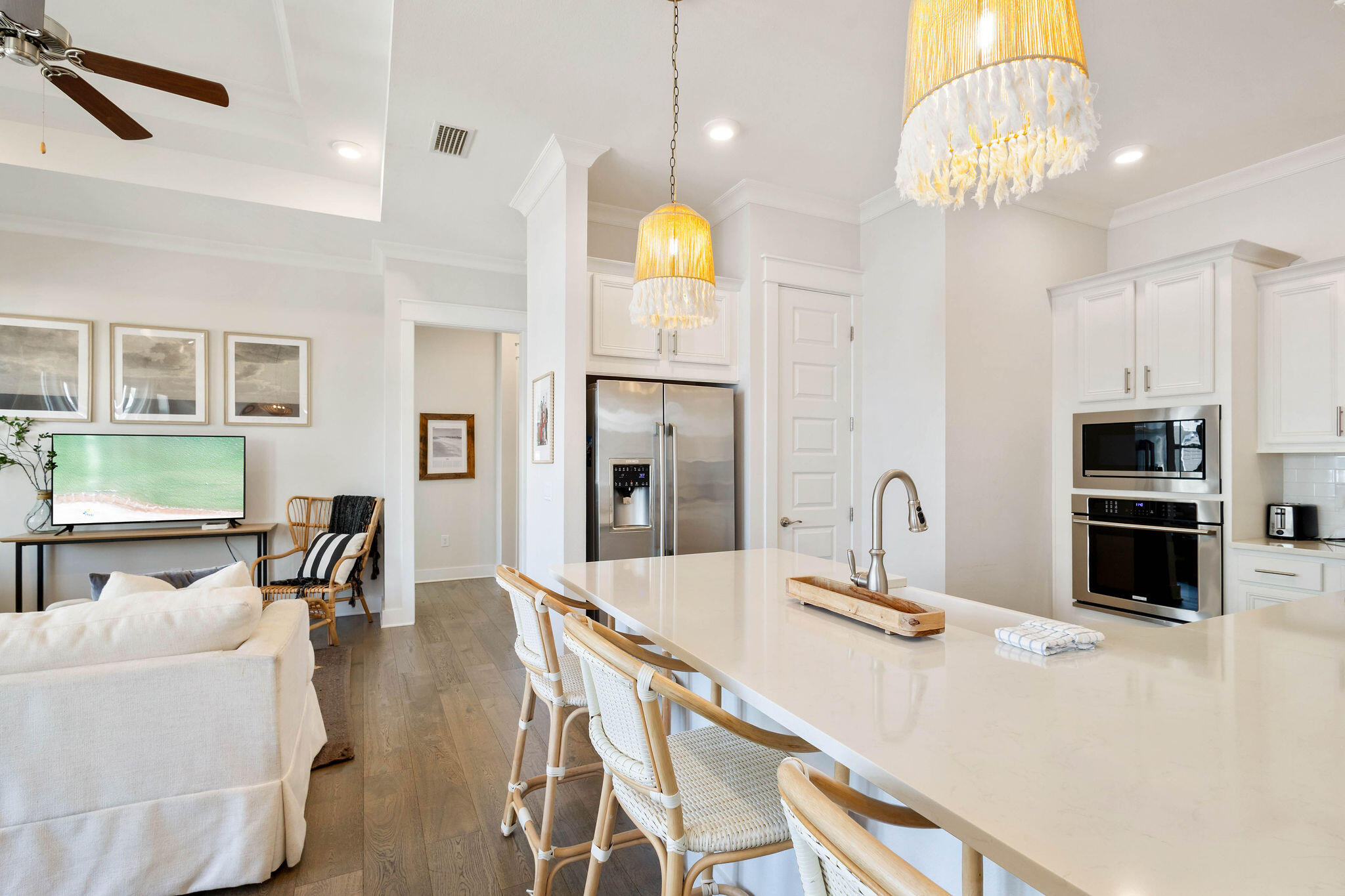 296 Milestone Dr Inlet Beach, Unit C Inlet Beach, FL 32461 - Photo 9 of 51 a kitchen with stainless steel appliances a dining table chairs stove refrigerator and microwave