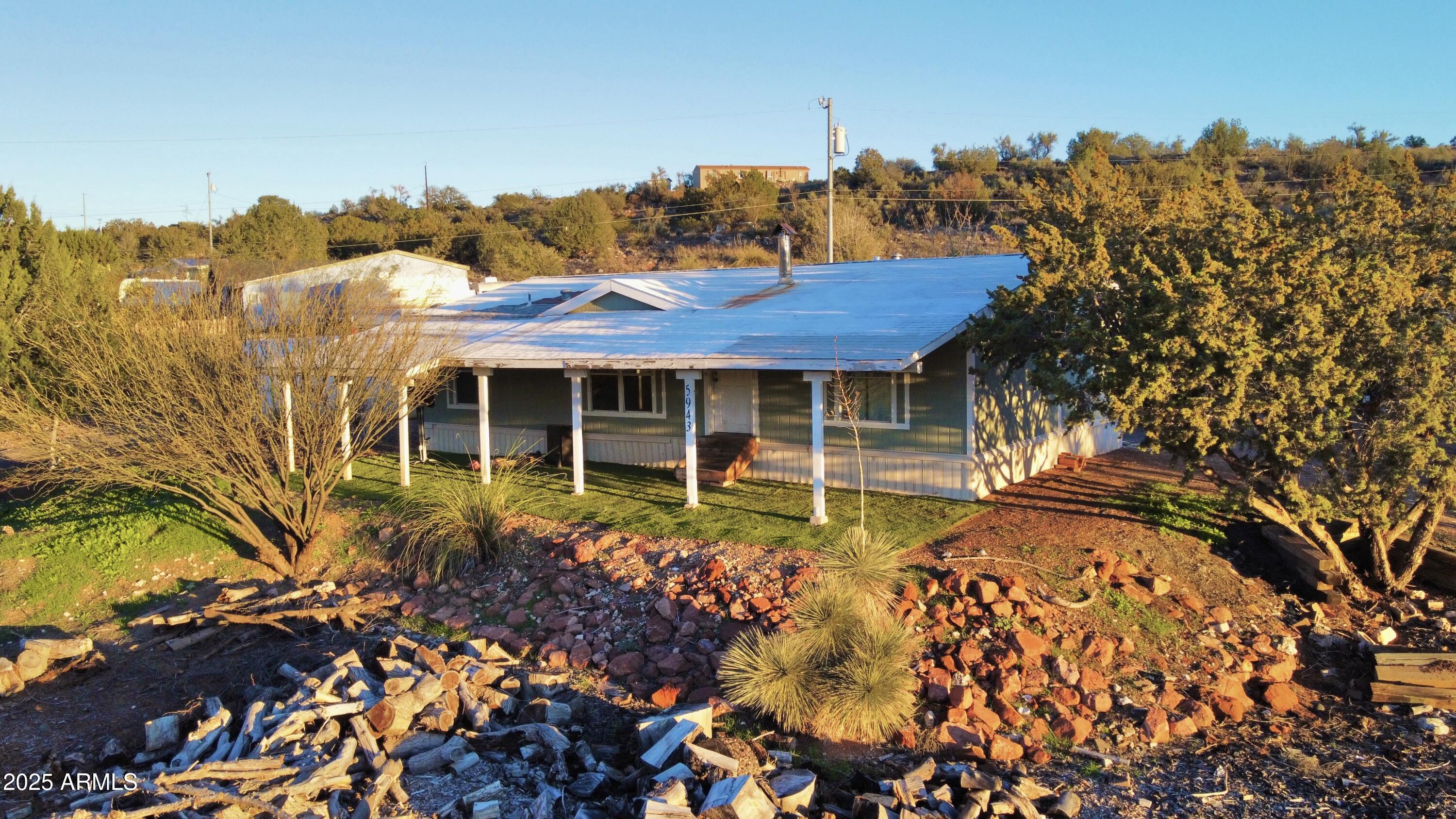 5943 North Bordeaux Road Rimrock, AZ 86335 - Photo 1 of 38 a front view of a house with a garden