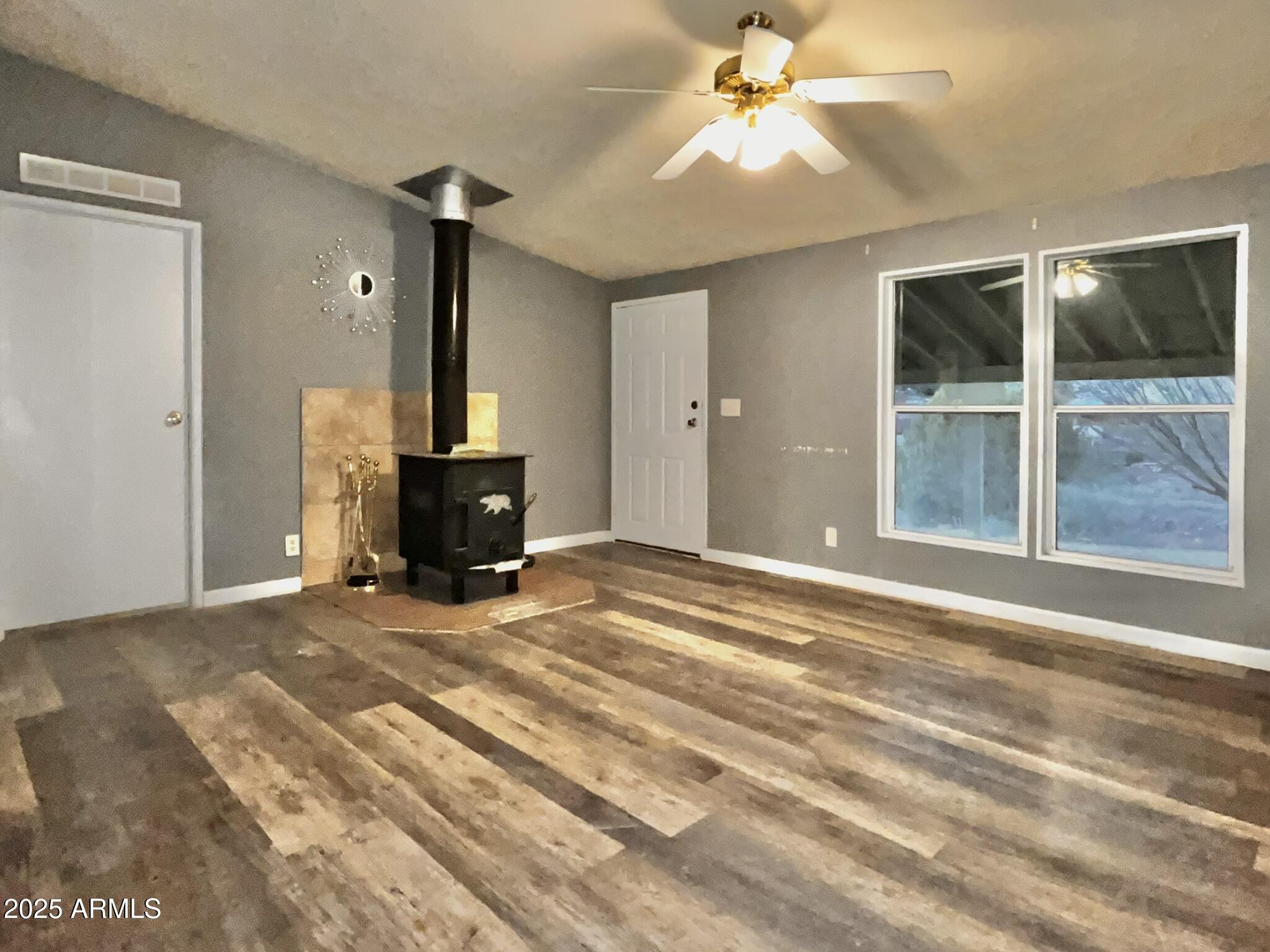 5943 North Bordeaux Road Rimrock, AZ 86335 - Photo 11 of 38 a view of a livingroom with wooden floor and a ceiling fan