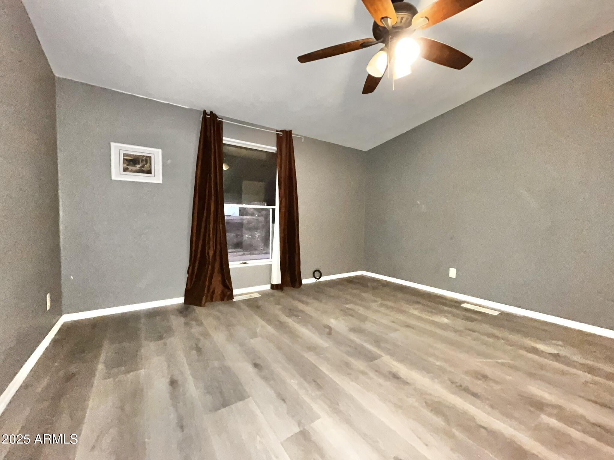 5943 North Bordeaux Road Rimrock, AZ 86335 - Photo 13 of 38 a view of an empty room with chandelier fan and a window