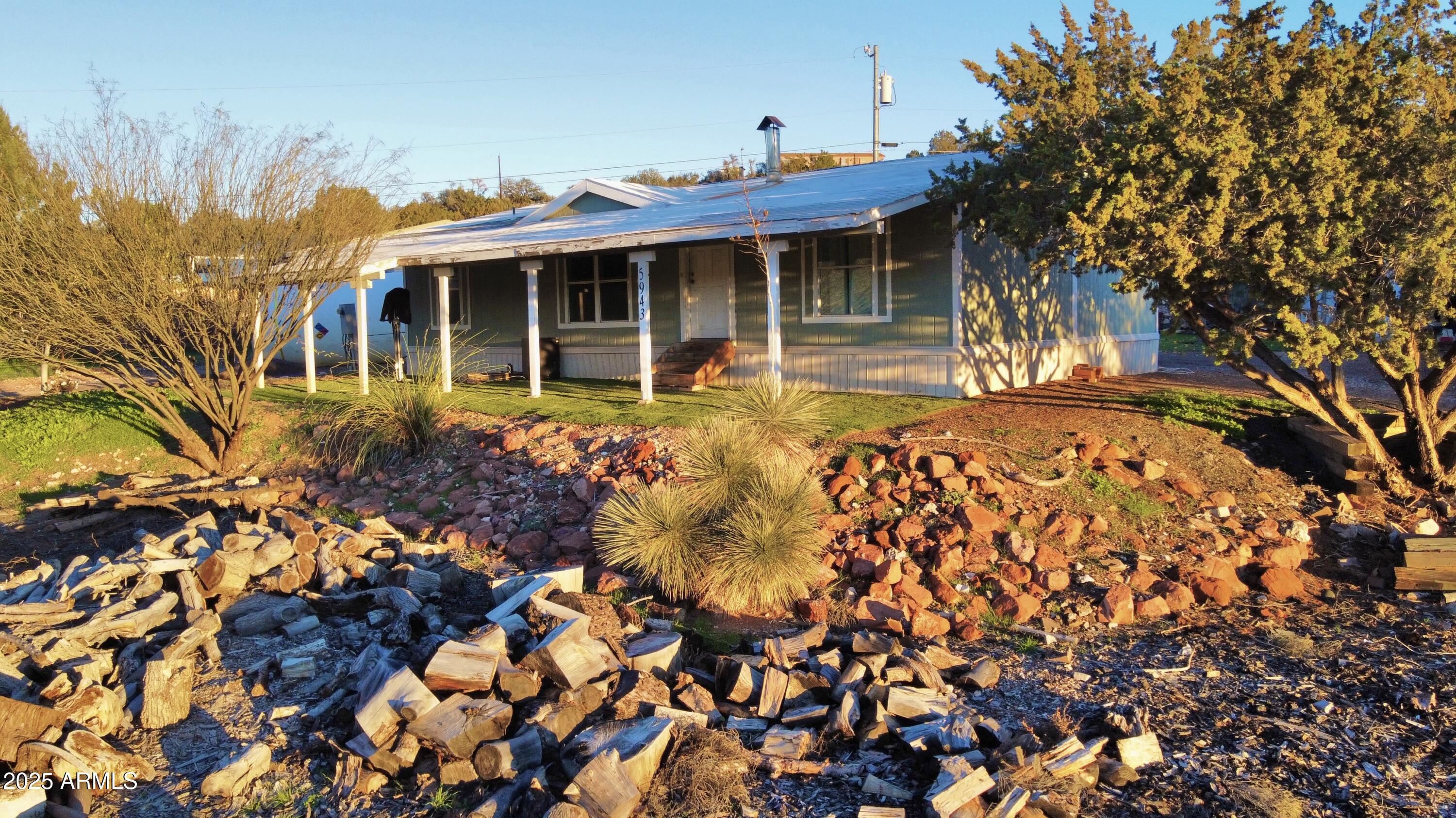 5943 North Bordeaux Road Rimrock, AZ 86335 - Photo 36 of 38 a view of a house with a small yard and potted plants
