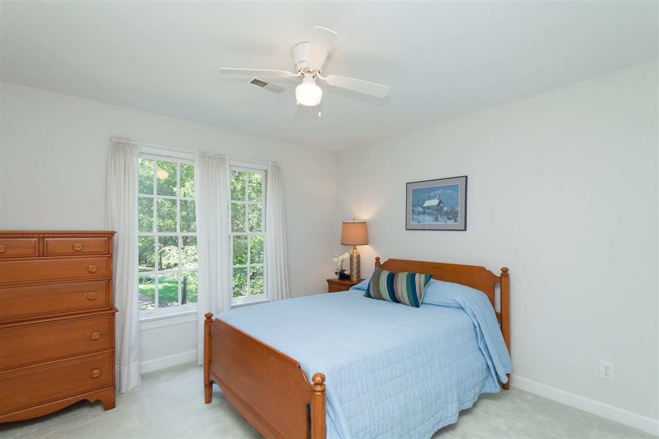 4124 Ridgebrook Bluffs Drive Raleigh, NC 27603 - Photo 20 of 24 Large closet, ceiling fan, neutral paint and carpet. Bedroom