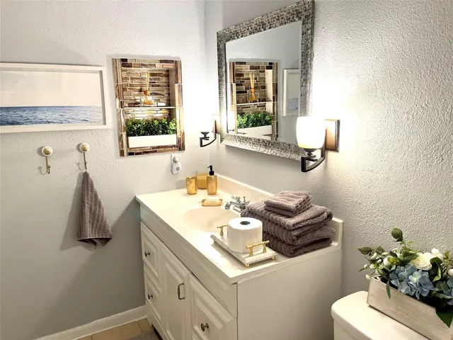 a bathroom with a sink a microwave and a refrigerator