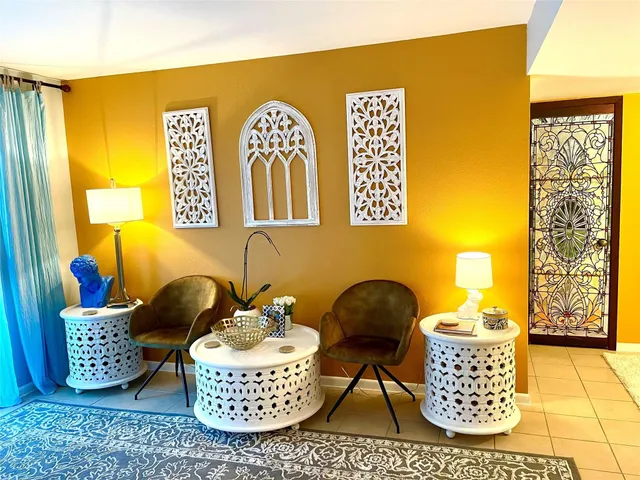 a view of living room with baby crib and dresser