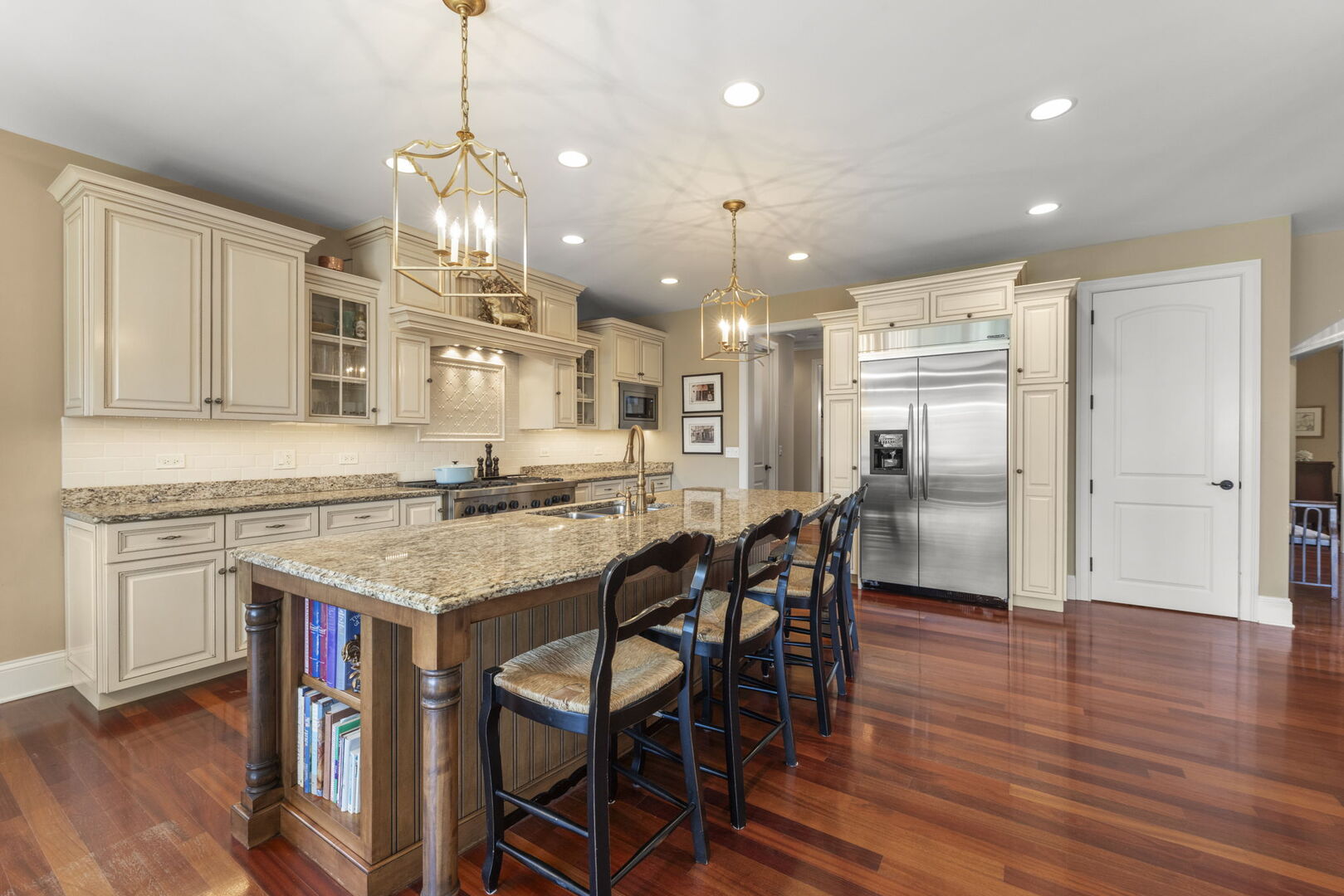 4804 Northcott Avenue Downers Grove, IL 60515 - Photo 11 of 36 a kitchen with stainless steel appliances kitchen island granite countertop a table chairs and a refrigerator
