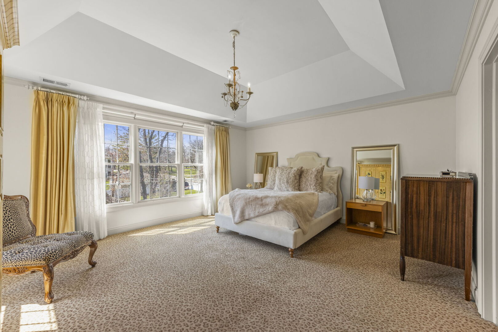 4804 Northcott Avenue Downers Grove, IL 60515 - Photo 19 of 36 a spacious bedroom with a bed and a dresser next to a window