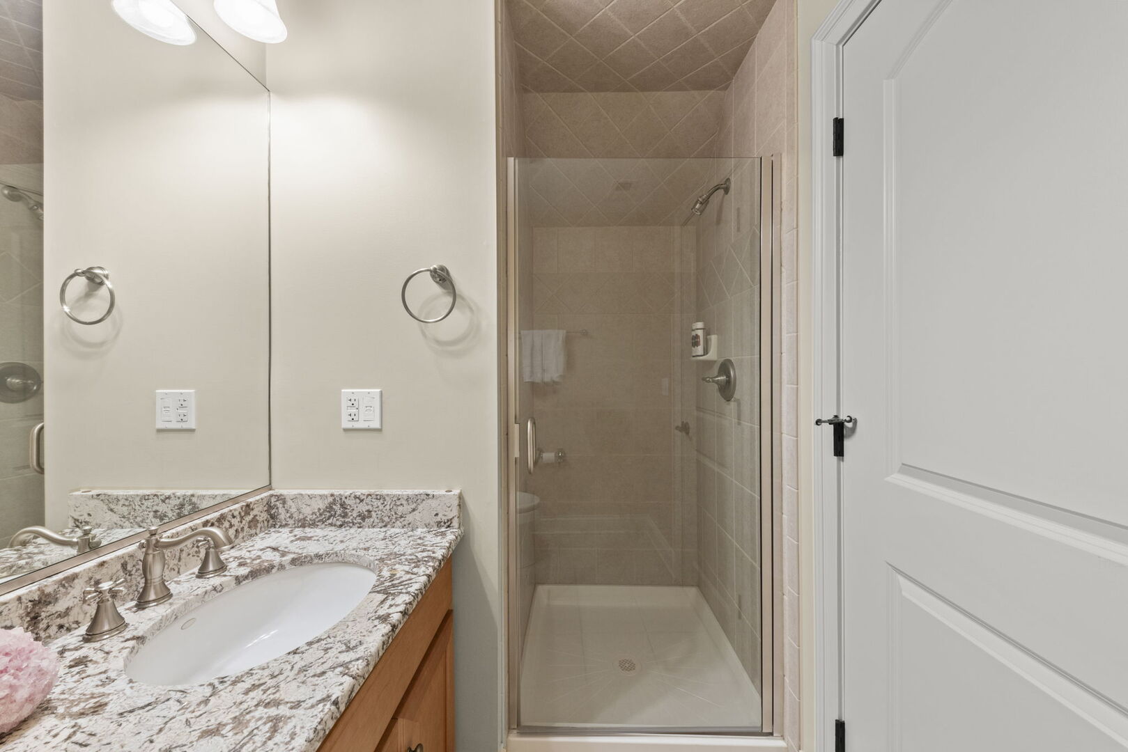 4804 Northcott Avenue Downers Grove, IL 60515 - Photo 24 of 36 a bathroom with a granite countertop sink a mirror and shower
