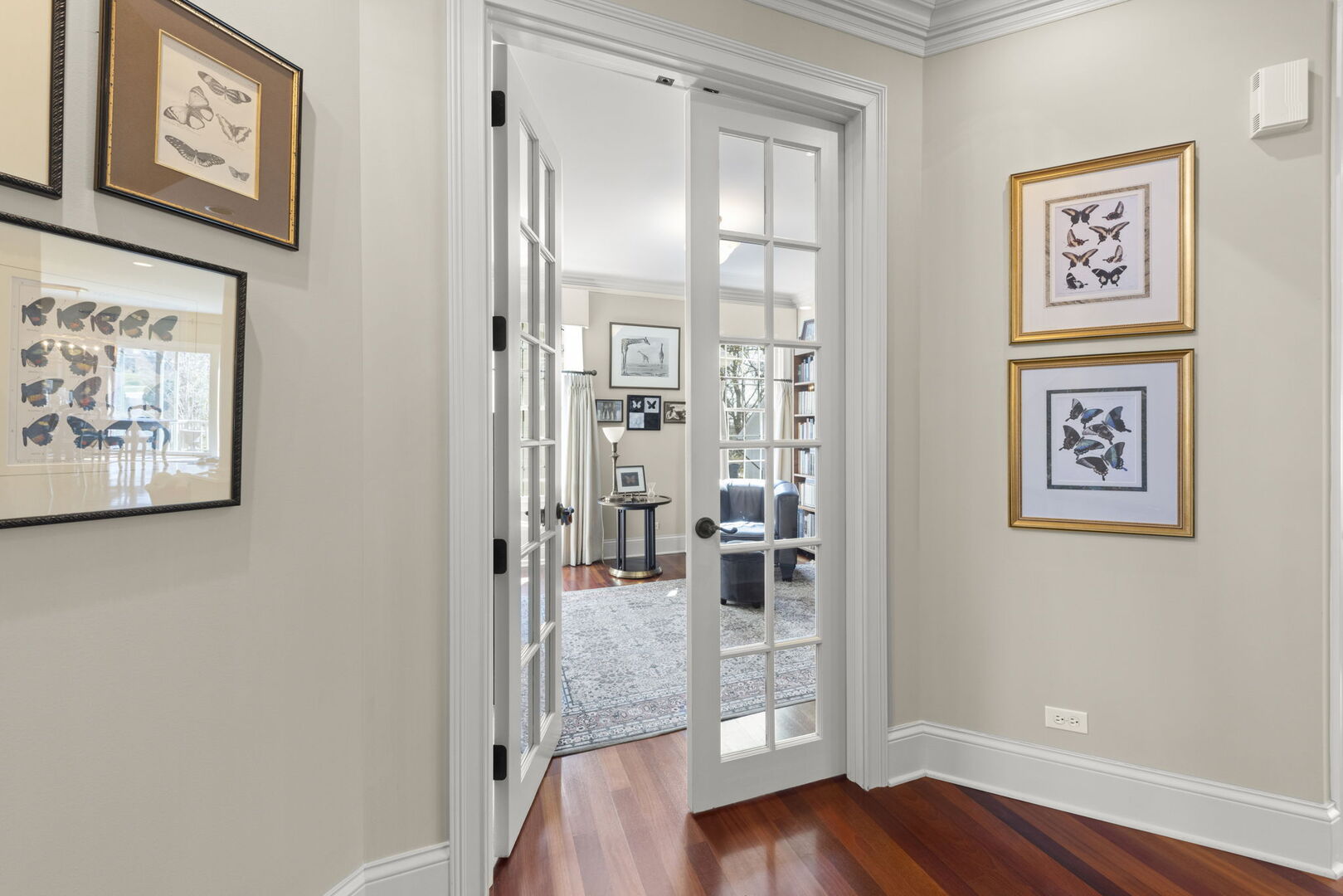 4804 Northcott Avenue Downers Grove, IL 60515 - Photo 6 of 36 a view of a hallway with wooden floor and a bookshelf