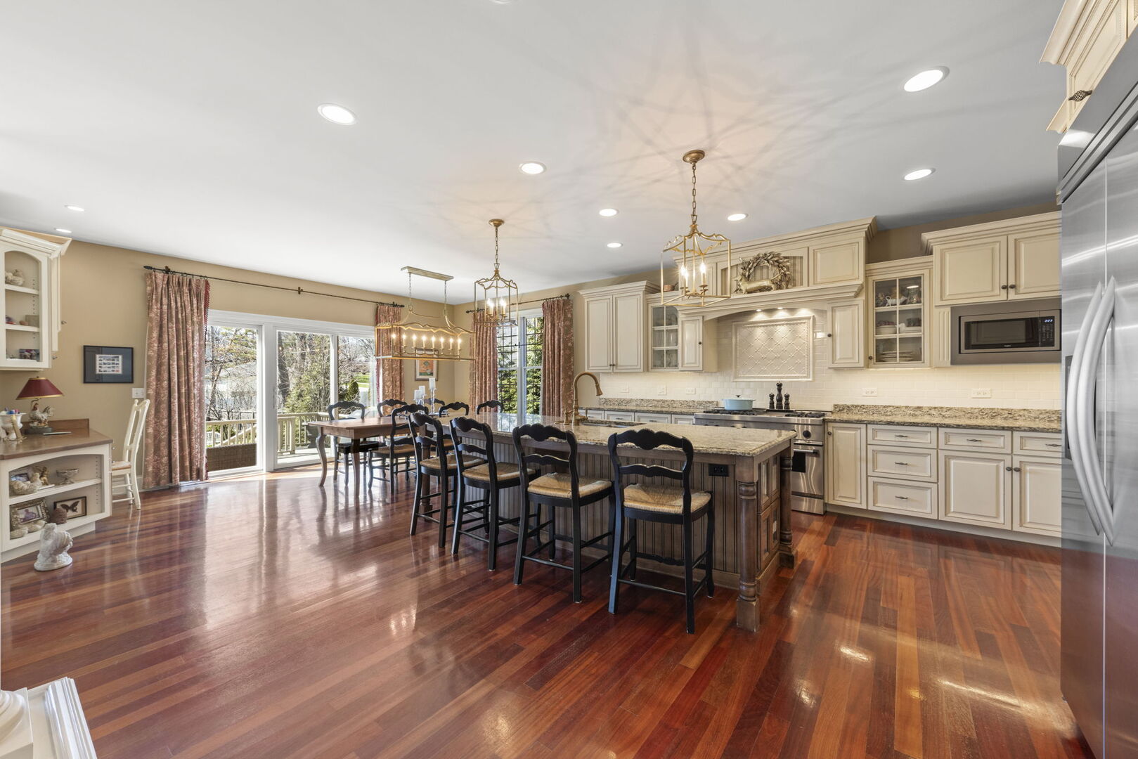 4804 Northcott Avenue Downers Grove, IL 60515 - Photo 10 of 36 a kitchen with stainless steel appliances granite countertop a stove top oven a sink dishwasher a dining table and chairs with wooden floor