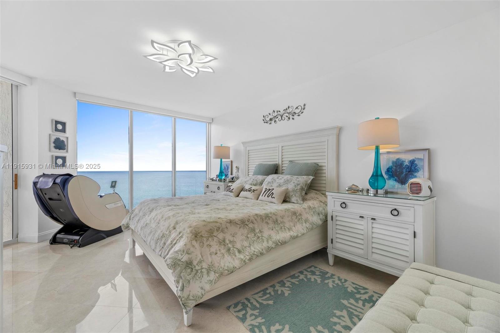 18671 Collins Avenue, Unit 1902 Sunny Isles Beach, FL 33160 - Photo 14 of 53 a bed room with a bed window and a chandelier