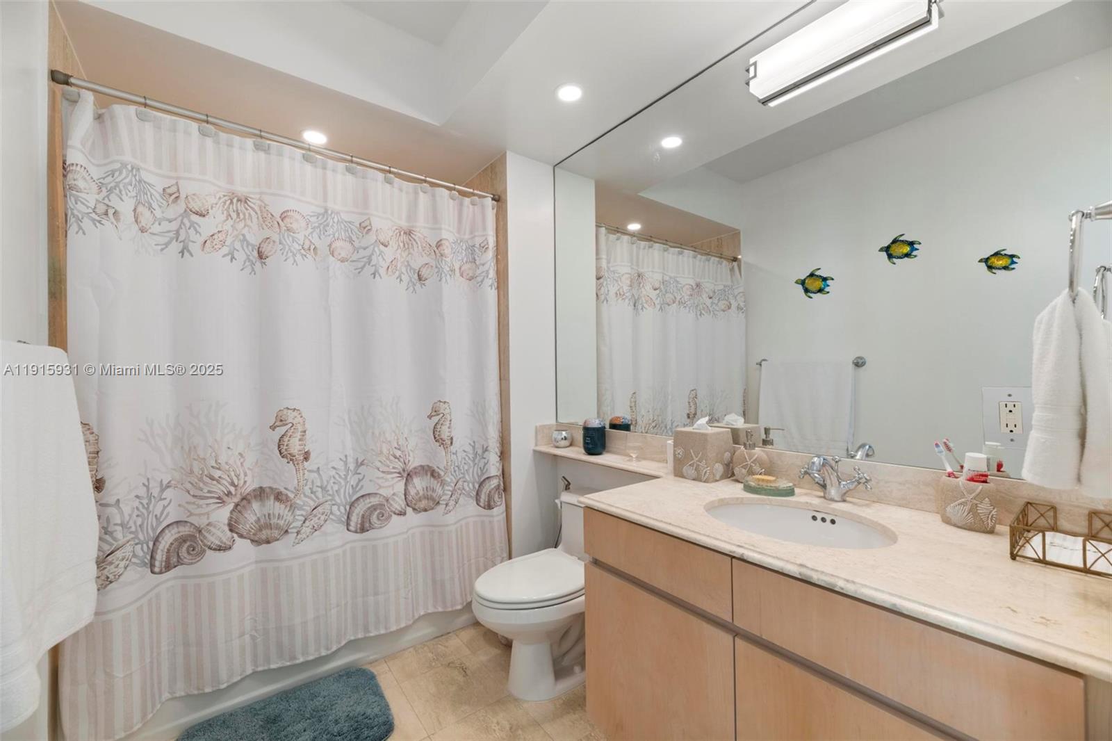 18671 Collins Avenue, Unit 1902 Sunny Isles Beach, FL 33160 - Photo 22 of 53 a bathroom with a double vanity sink toilet and shower