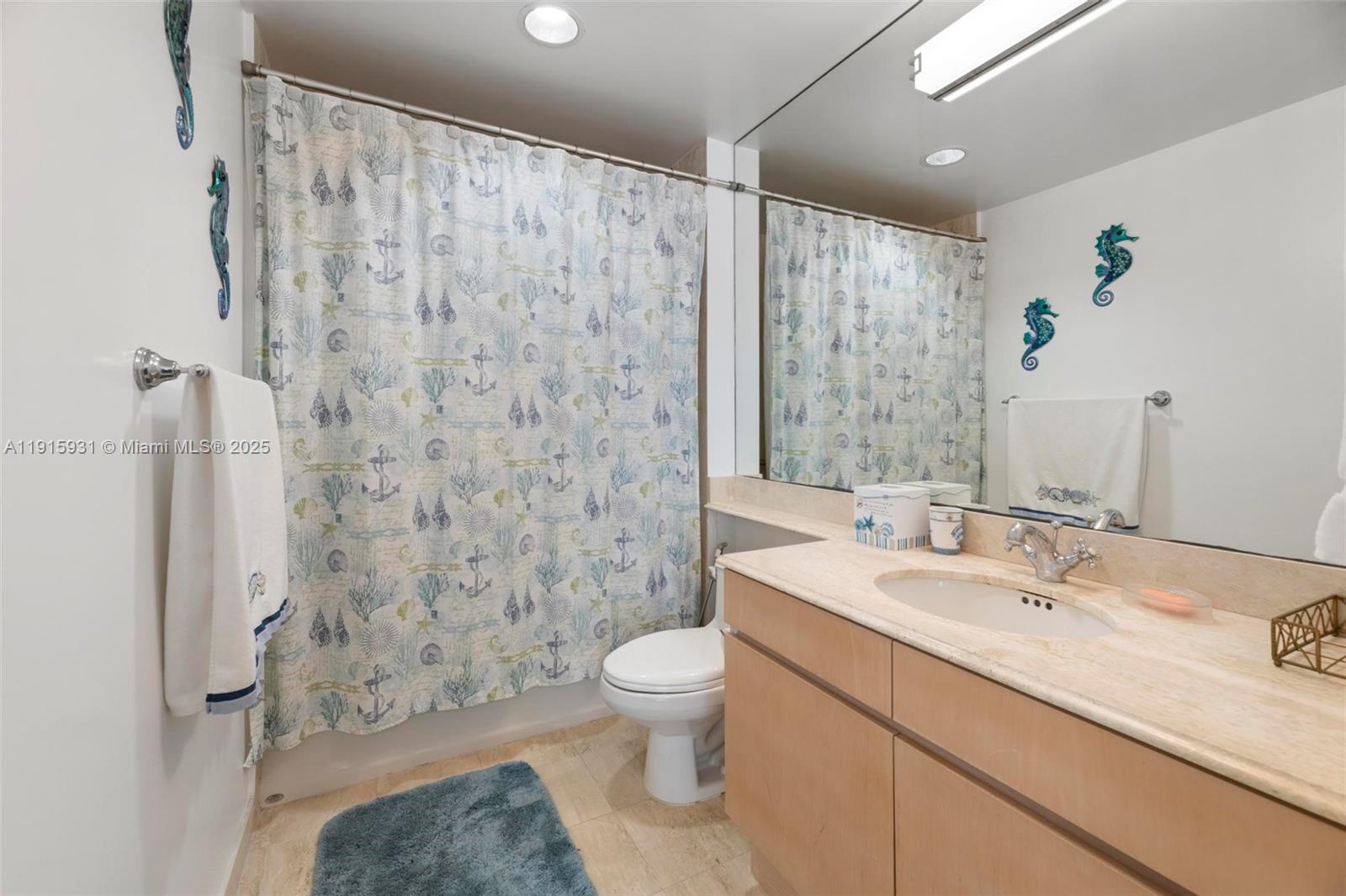 18671 Collins Avenue, Unit 1902 Sunny Isles Beach, FL 33160 - Photo 25 of 53 a bathroom with a granite countertop sink a toilet and a shower