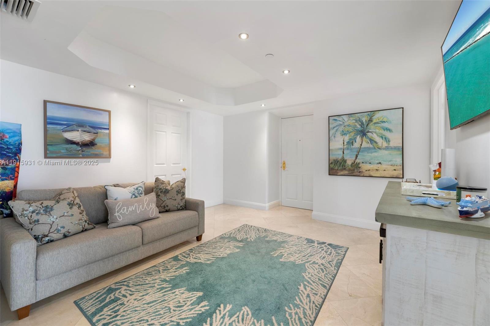 18671 Collins Avenue, Unit 1902 Sunny Isles Beach, FL 33160 - Photo 26 of 53 a living room with furniture and painting on the wall