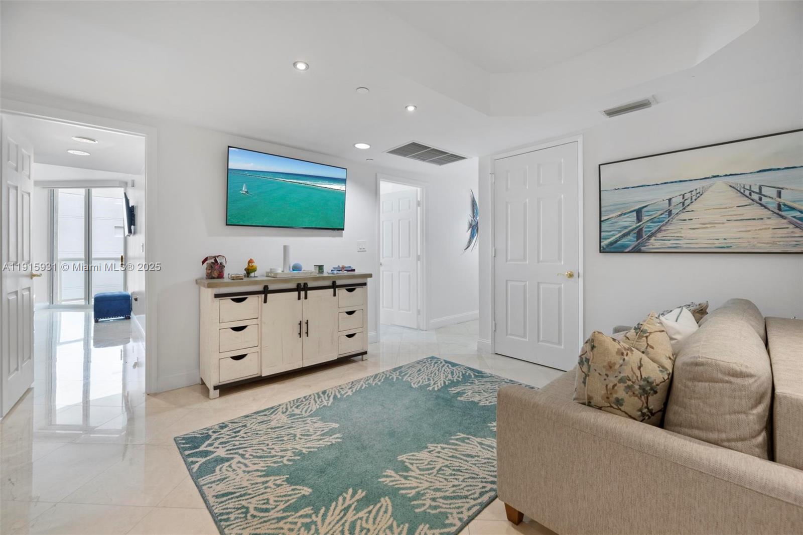 18671 Collins Avenue, Unit 1902 Sunny Isles Beach, FL 33160 - Photo 27 of 53 a living room with furniture and a dresser
