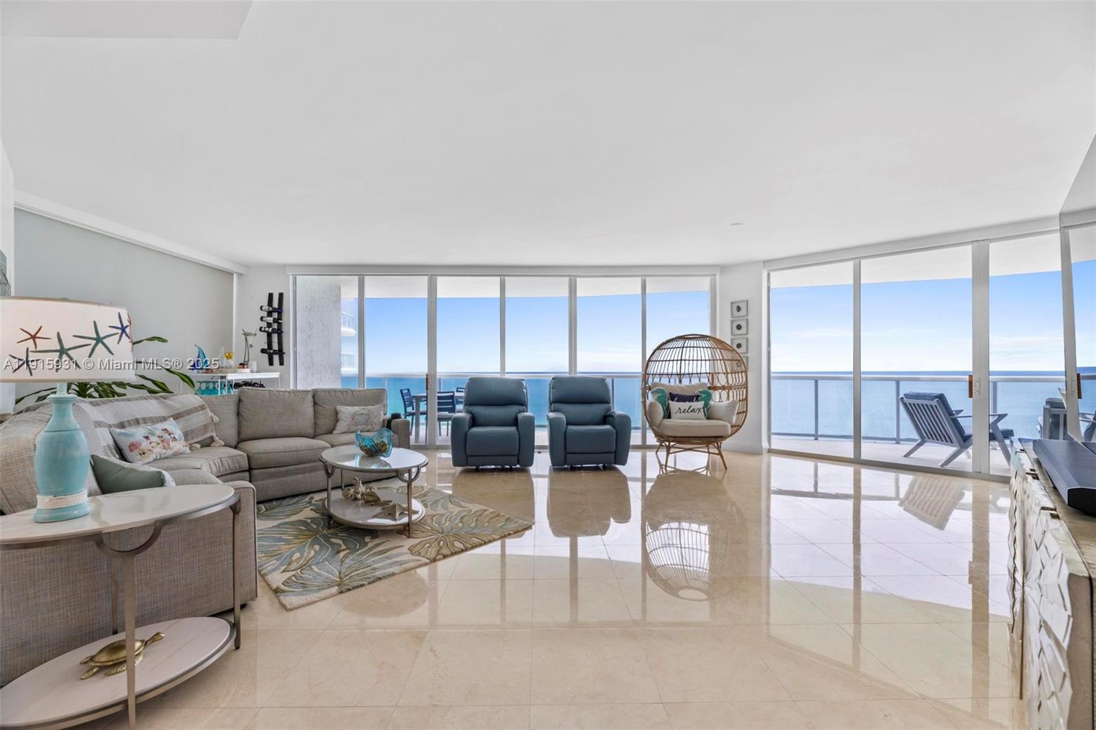 18671 Collins Avenue, Unit 1902 Sunny Isles Beach, FL 33160 - Photo 3 of 53 a living room with furniture and a window