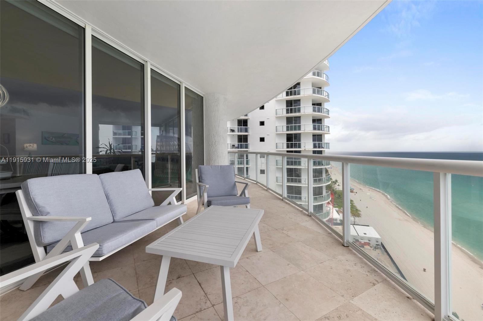 18671 Collins Avenue, Unit 1902 Sunny Isles Beach, FL 33160 - Photo 31 of 53 a balcony with table and chairs